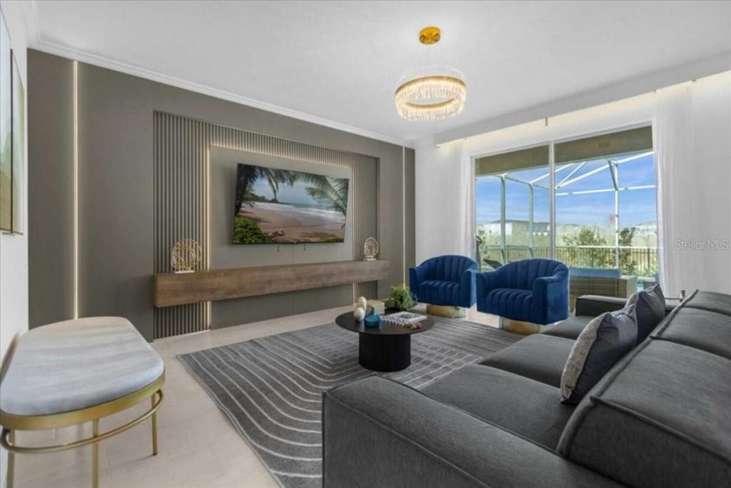 A modern living room features a slatted accent wall, floating shelf, and blue velvet chairs — 8967 PLAY THROUGH DR, DAVENPORT, FL