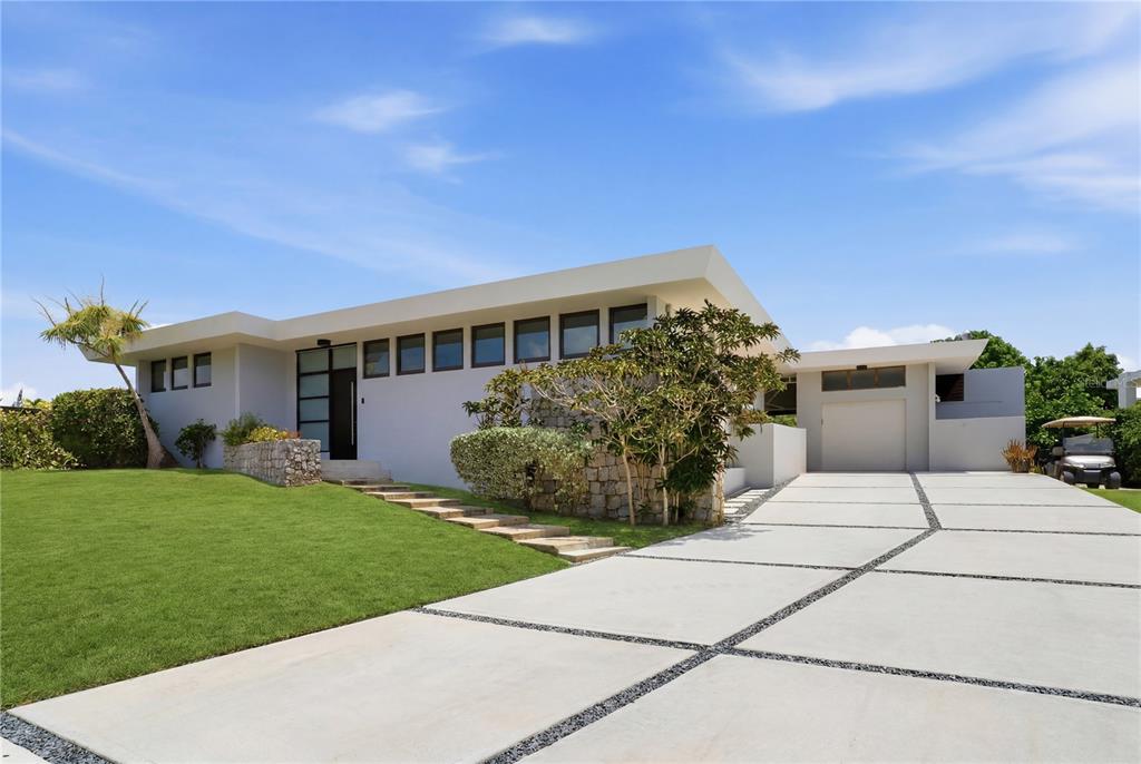 A modern, single-story house with a flat roof, stone accents, and a concrete driveway — 176 CALLE MIMOSA, SAN JUAN, PR