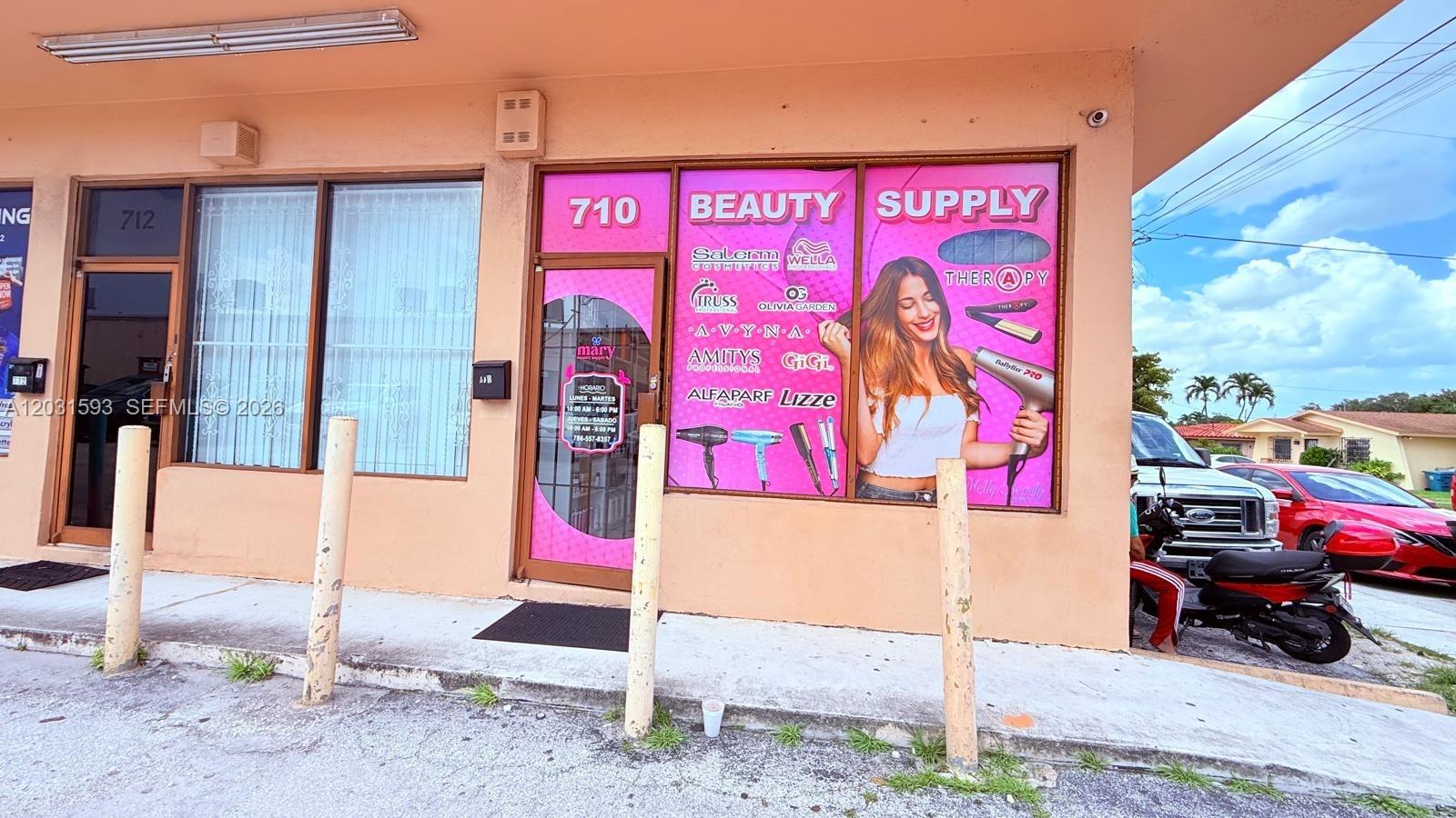 The exterior of a commercial building features a beauty supply store with large window decals — Beauty Supply Store, Miami FL 33125, MIAMI, FL