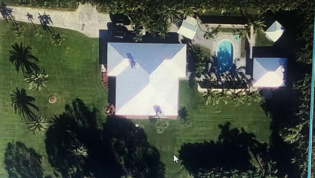 An aerial view shows a house with a pool, surrounding lawn, and dense trees — 16826 126th Terrace N, Jupiter FL 33478, JUPITER, FL