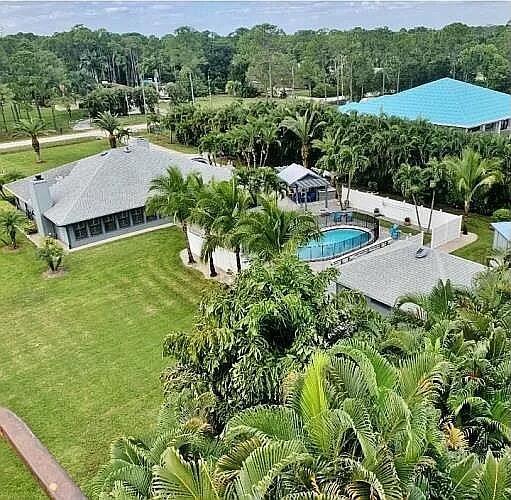 An aerial view shows a house with a gray roof, a pool, and surrounding landscaping — 16826 126th Terrace N, Jupiter FL 33478, JUPITER, FL
