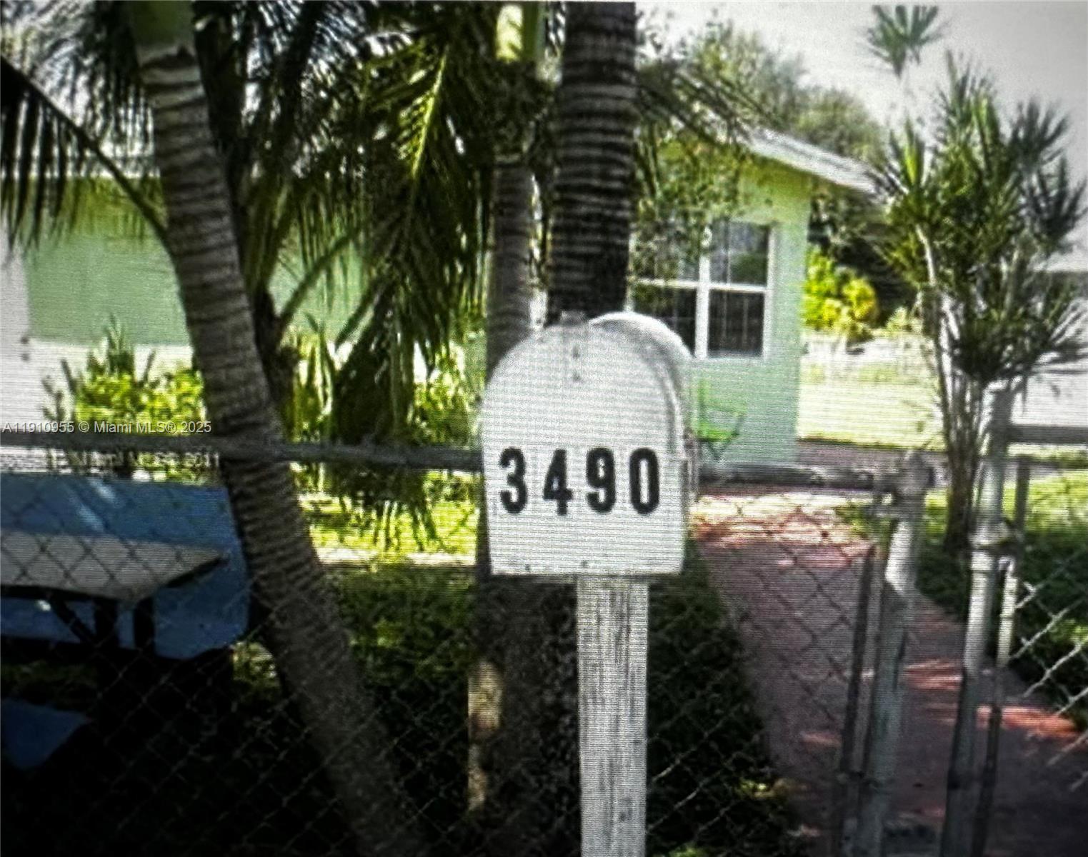 A mailbox with the number 3490 stands in front of a house and palm trees — 3490 SW 56th Ave, West Park FL 33023, WEST PARK, FL