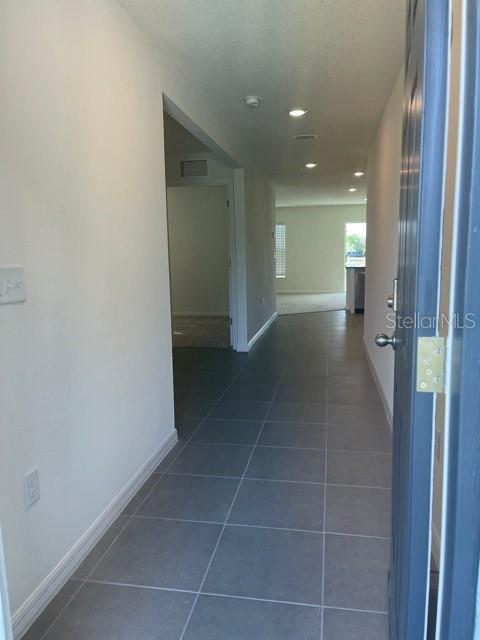 A light blue single-story house with a two-car garage and a concrete driveway — 10231 OPALINE SKY COURT, RIVERVIEW, FL