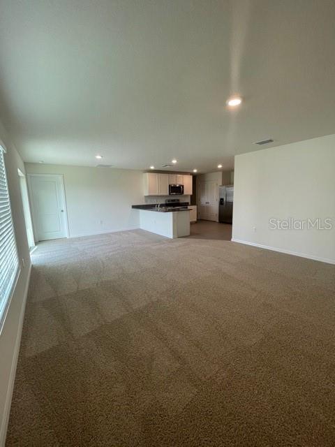 A kitchen with white cabinets, granite countertops, stainless steel appliances, and tile flooring — 10231 OPALINE SKY COURT, RIVERVIEW, FL