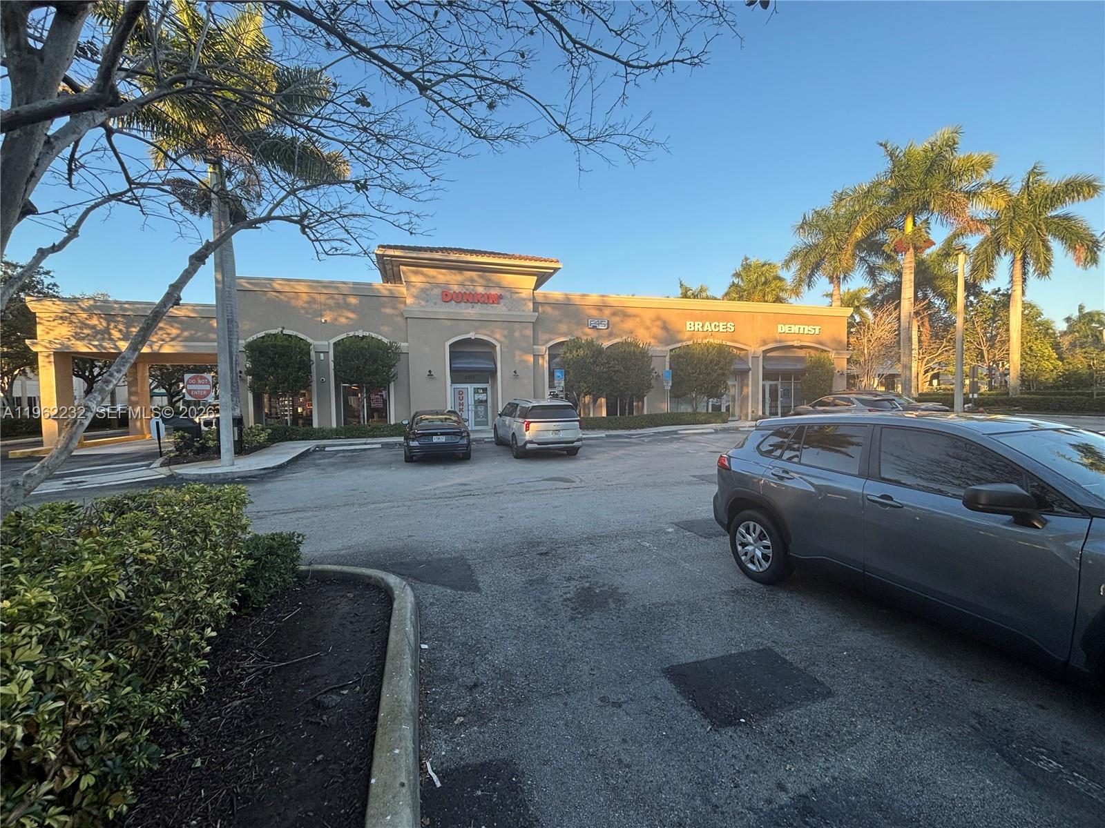A commercial strip mall features a Dunkin' store, a dentist's office, and a parking lot — 2575 Glades Cir, Weston FL 33327, WESTON, FL
