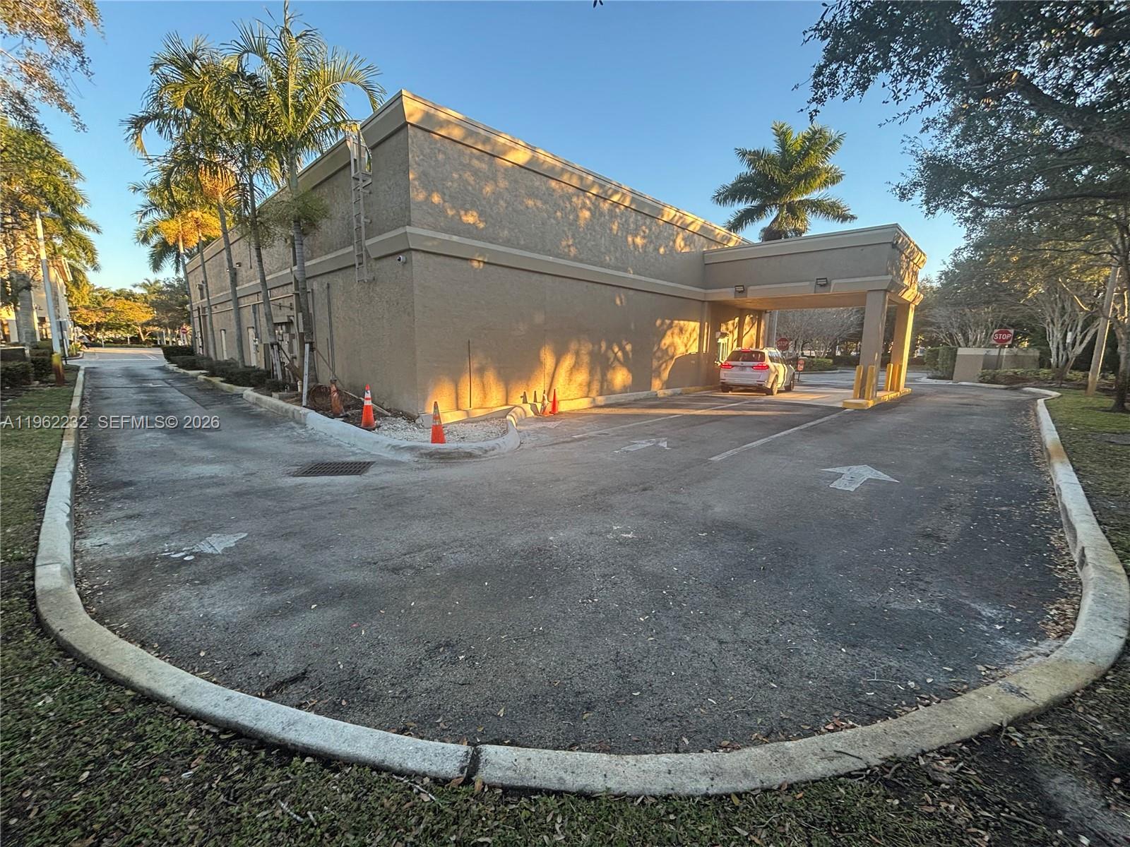 The exterior of a commercial building features a drive-thru lane with a covered canopy — 2575 Glades Cir, Weston FL 33327, WESTON, FL