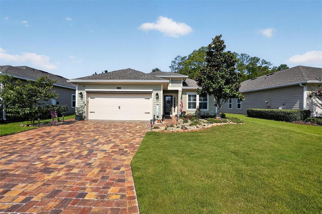 A single-story house with a paved driveway, a two-car garage, and a landscaped front yard — 194 ANGUILLA BOULEVARD, ST AUGUSTINE, FL