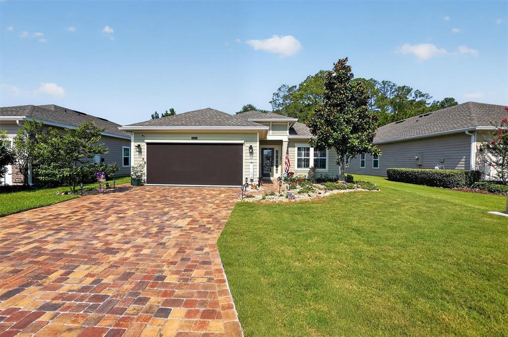 A single-story house with a brick paver driveway, a garage, and a landscaped front yard — 194 ANGUILLA BOULEVARD, ST AUGUSTINE, FL