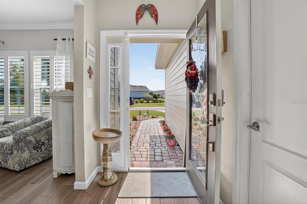 An open front door reveals a brick walkway leading to a suburban street — 194 ANGUILLA BOULEVARD, ST AUGUSTINE, FL
