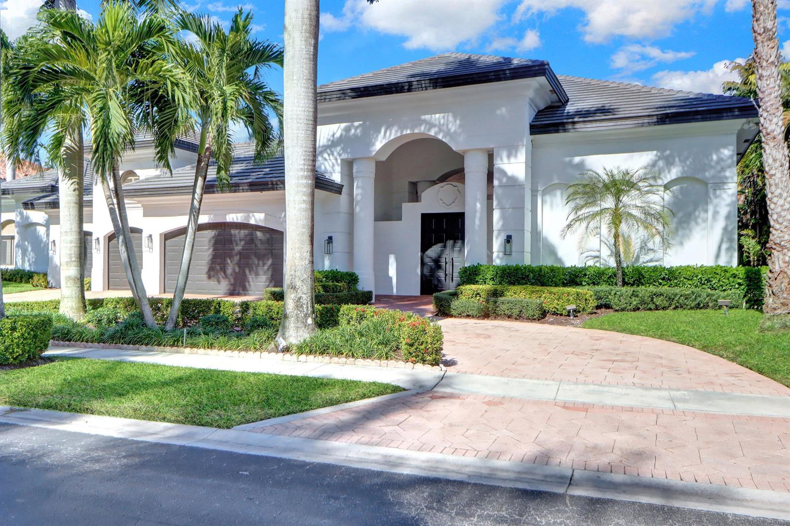 A white single-story house with a tiled roof, arched entryway, and a paved driveway — 3799 Coventry Lane, Boca Raton FL 33496, BOCA RATON, FL