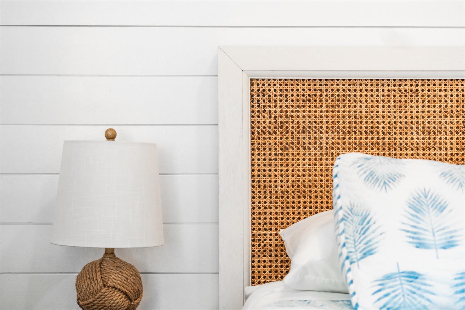A white shiplap wall features a cane headboard and a rope-base table lamp — 353 S Us Highway 1 # A6, Jupiter FL 33477, JUPITER, FL
