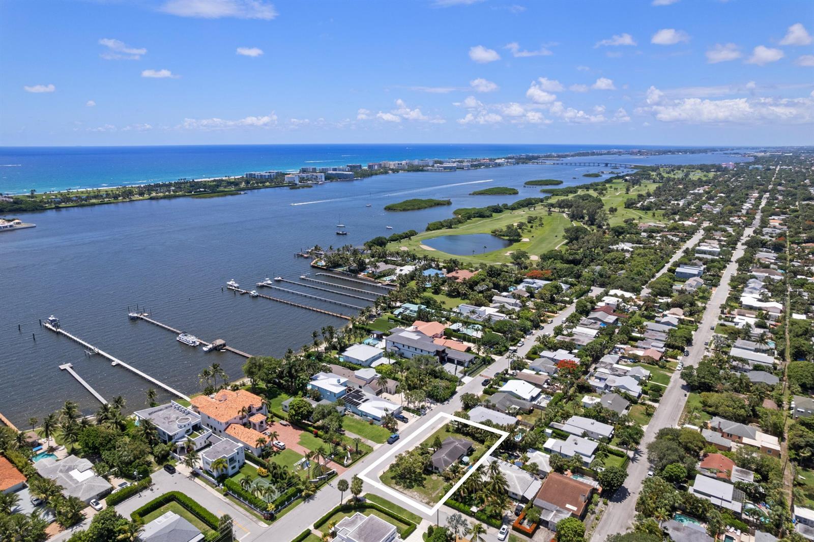 An aerial view shows a residential property highlighted in white within a coastal neighborhood — 1725 N Lakeside Drive, FL 33460, FL