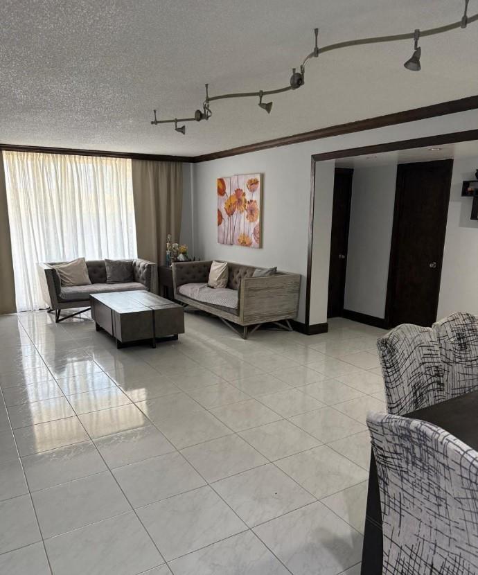 A living room with tile flooring, track lighting, two sofas, and a coffee table — 1833 S Ocean Drive # 1209, FL 33009, FL