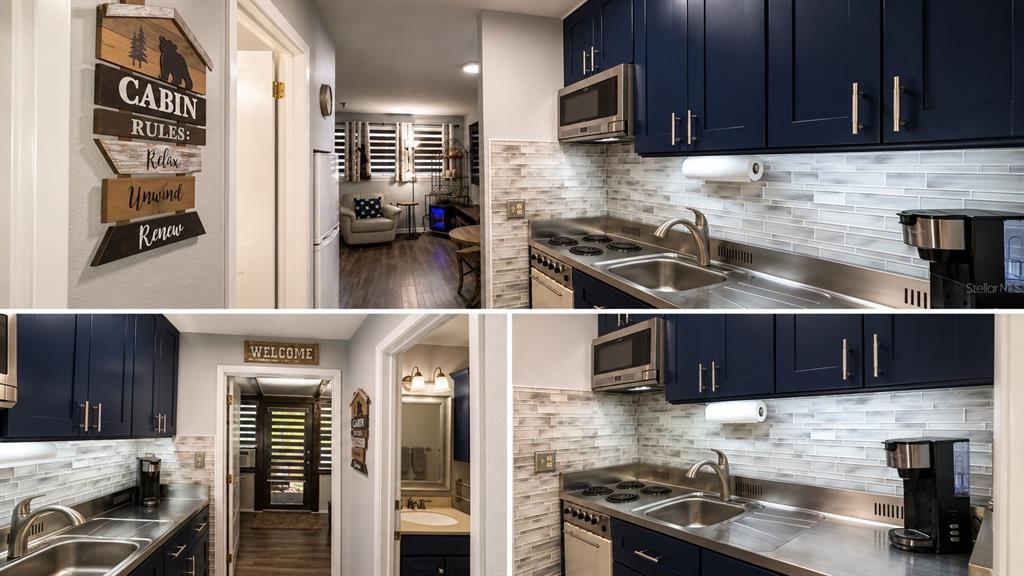 A kitchen with dark blue cabinets, stainless steel countertops, and a light-colored tile backsplash — 3200 RIVER RANCH BOULEVARD UNIT 303, LAKE WALES, FL
