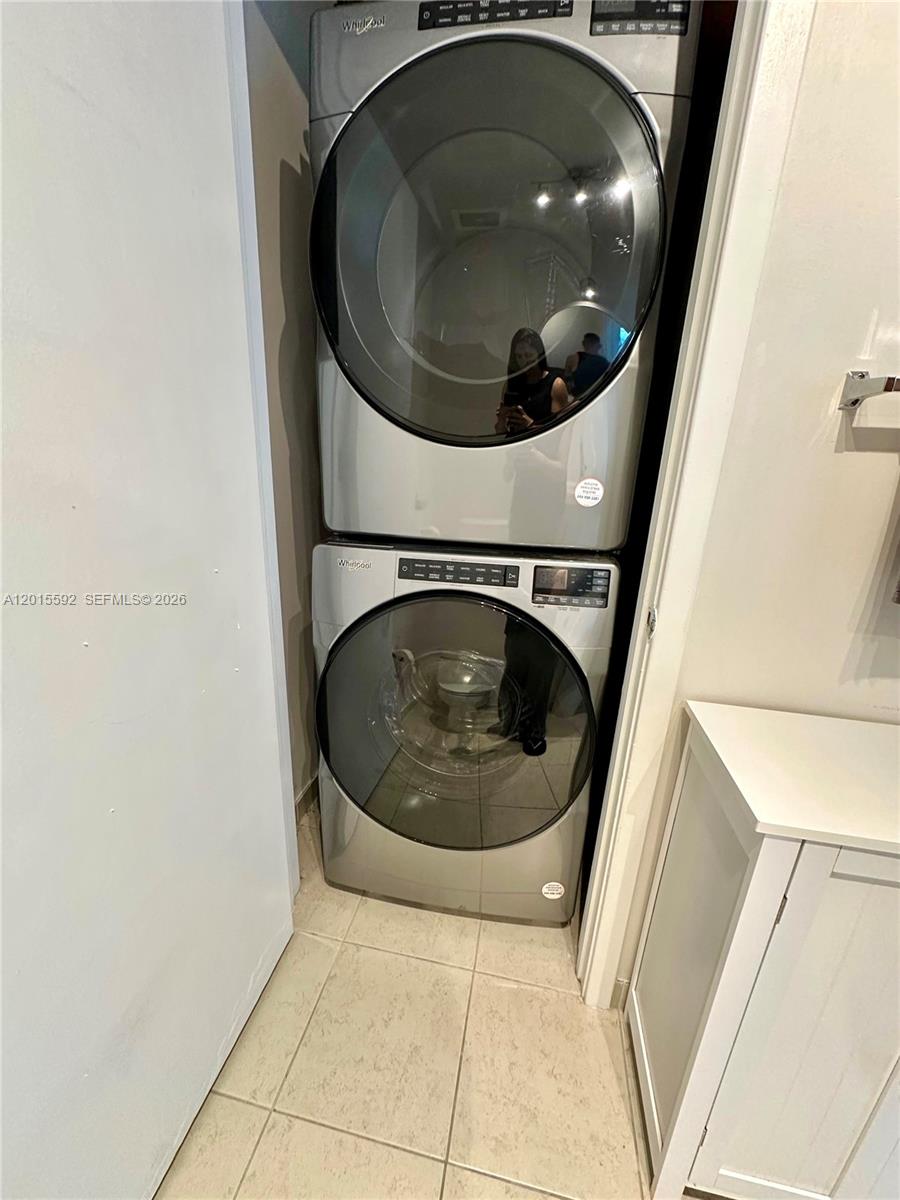 A stacked Whirlpool washer and dryer unit is installed in a small laundry closet — 3301 NE 1st Ave # H1811, Miami FL 33137, MIAMI, FL