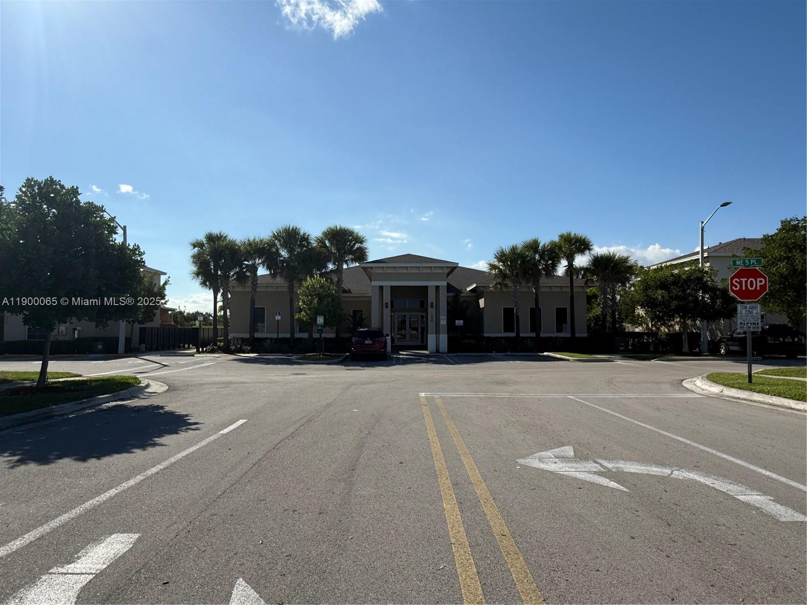 A single-story commercial building with a central entrance stands behind a paved parking lot — 484 NE 5th St, Florida City FL 33034, FLORIDA CITY, FL