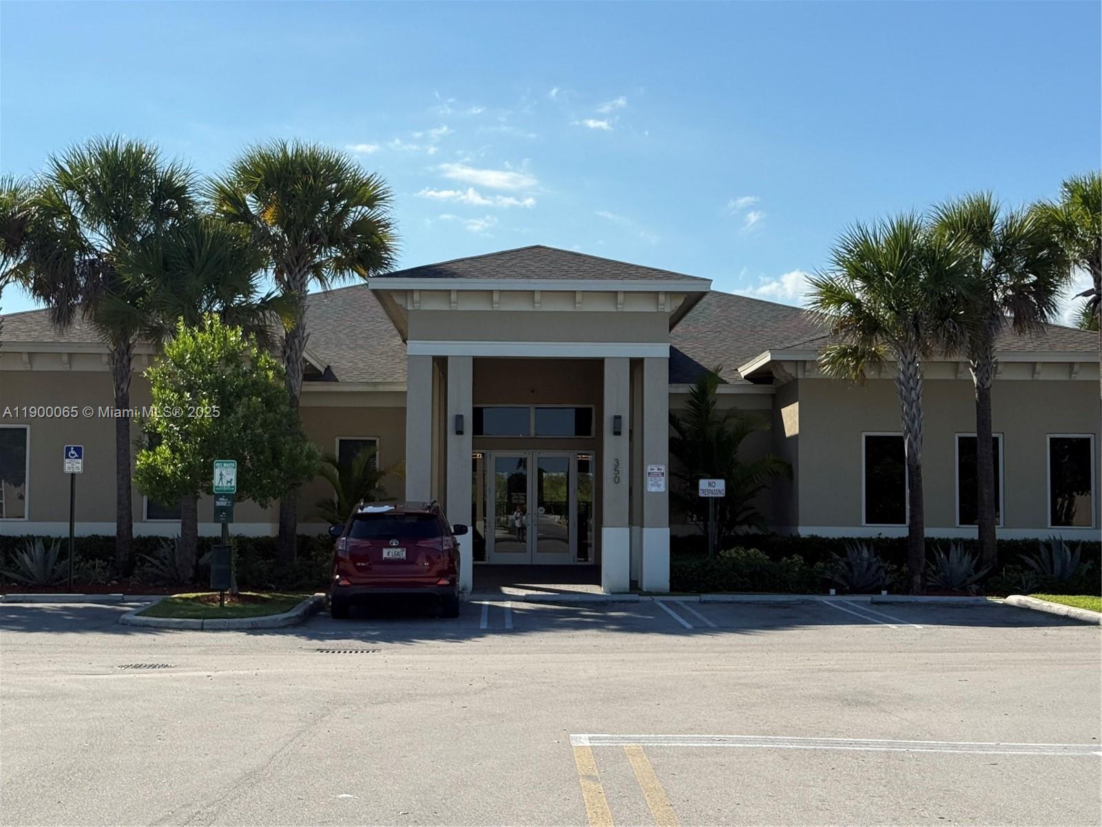 A single-story commercial building with a covered entrance and palm trees in the parking lot — 484 NE 5th St, Florida City FL 33034, FLORIDA CITY, FL