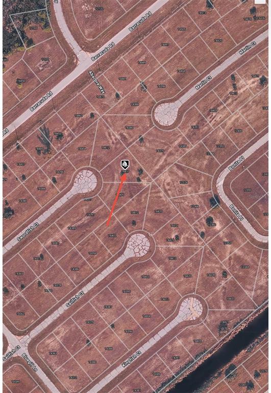 This is an aerial map showing a vacant residential lot marked with a red arrow — 14417 SWORDFISH COURT, PLACIDA, FL