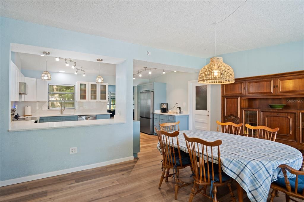 A dining area with a wooden hutch and a pass-through window to the kitchen — 1840 N POWERS DRIVE, ORLANDO, FL