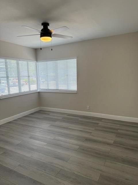 An empty room features light-colored walls, gray wood-look flooring, and a ceiling fan — 112 Lake Avenue # 5, FL 33460, FL