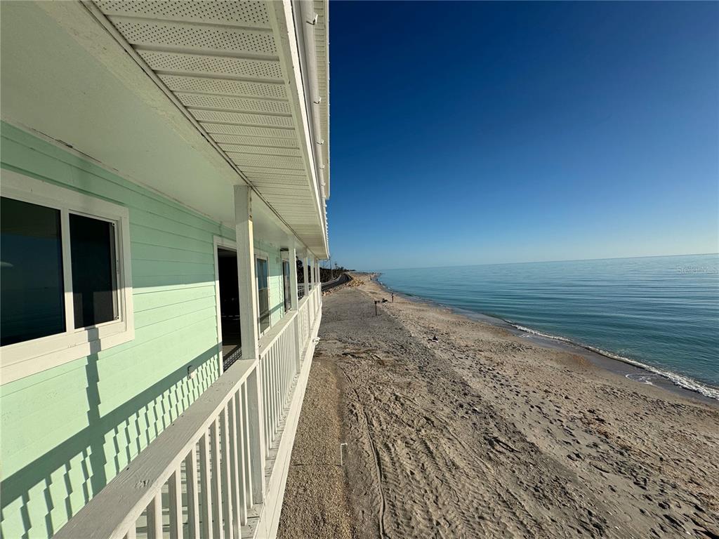 A view from a balcony overlooking a sandy beach and the ocean — 6780 MANASOTA KEY ROAD, ENGLEWOOD, FL