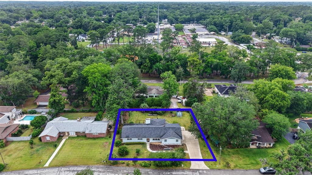 An aerial view shows a single-story house with a gray roof and a concrete driveway — 550 SE 39TH TERRACE, OCALA, FL