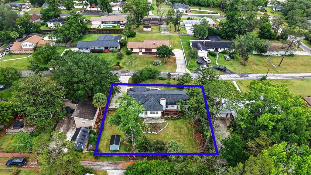 An aerial view shows a single-story house with a dark roof and a fenced backyard — 550 SE 39TH TERRACE, OCALA, FL