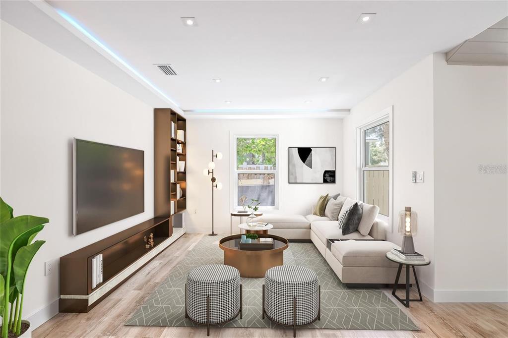 A modern living room features a large sectional sofa, a wall-mounted television, and built-in shelving — 6907 20TH STREET, TAMPA, FL