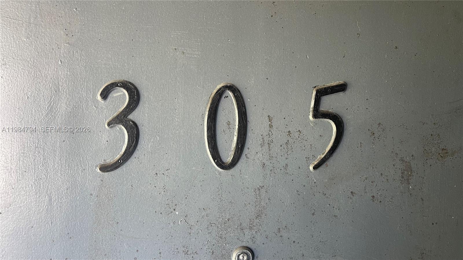 The number 305 is mounted on a gray door — 13700 NE 6th Ave # 305, North Miami FL 33161, NORTH MIAMI, FL