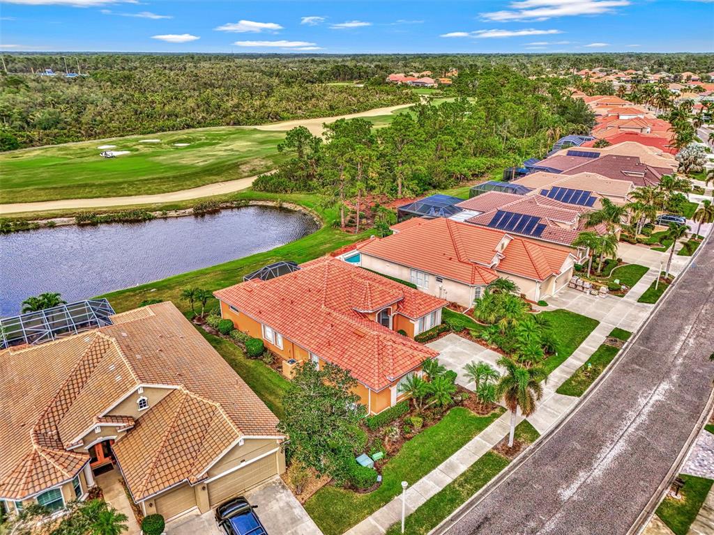 An aerial view of suburban houses with red tile roofs bordering a golf course — 1151 CREEK NINE DRIVE, NORTH PORT, FL