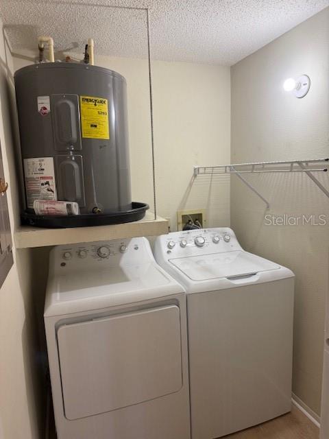 A laundry room featuring a water heater mounted above a washer and dryer set — 4022 BEAVER LANE UNIT 1000A, PORT CHARLOTTE, FL