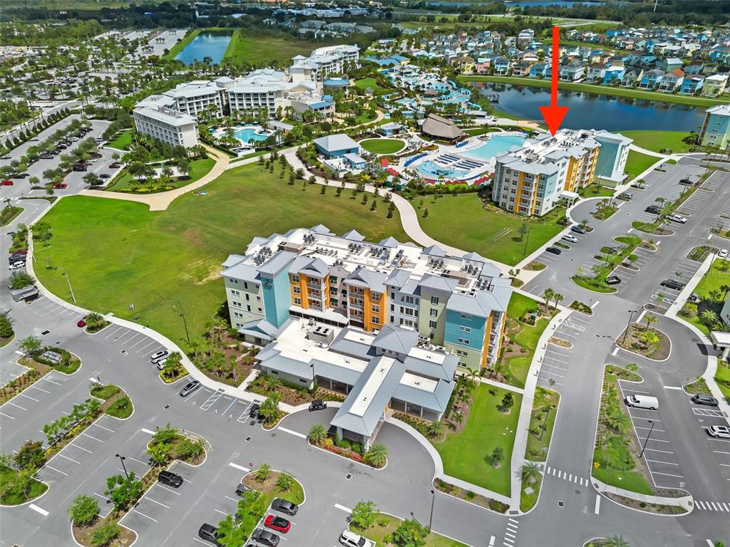 An aerial view shows a multi-story resort building with a pool and surrounding parking lots — 8061 VACATION AVENUE UNIT 2307, KISSIMMEE, FL