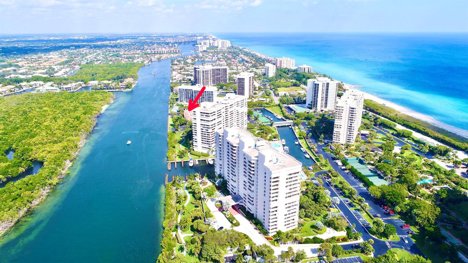 An aerial view shows high-rise residential buildings situated along a waterway near the ocean — 4501 N Ocean Boulevard # 04, Boca Raton FL 33431, BOCA RATON, FL