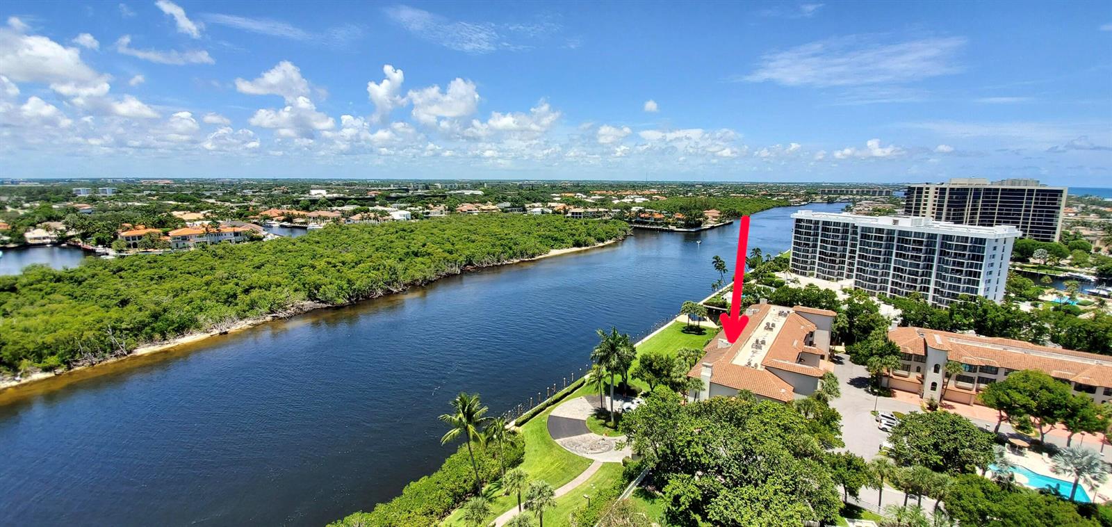 An aerial view of a waterfront residential complex with a red arrow pointing to a building — 4501 N Ocean Boulevard # 04, Boca Raton FL 33431, BOCA RATON, FL