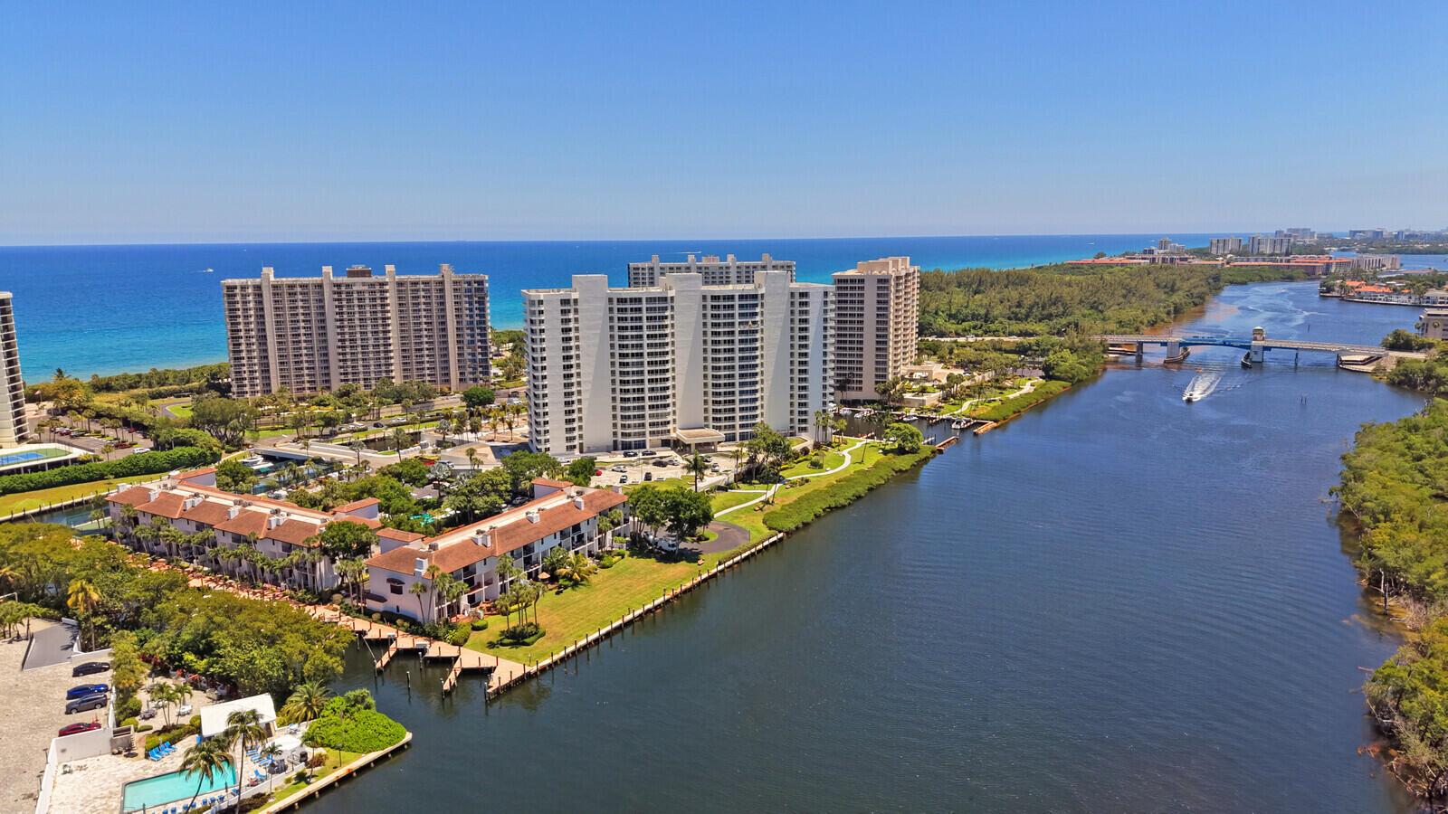 An aerial view of waterfront condominiums, a canal, a bridge, and the ocean beyond — 4501 N Ocean Boulevard # 04, Boca Raton FL 33431, BOCA RATON, FL