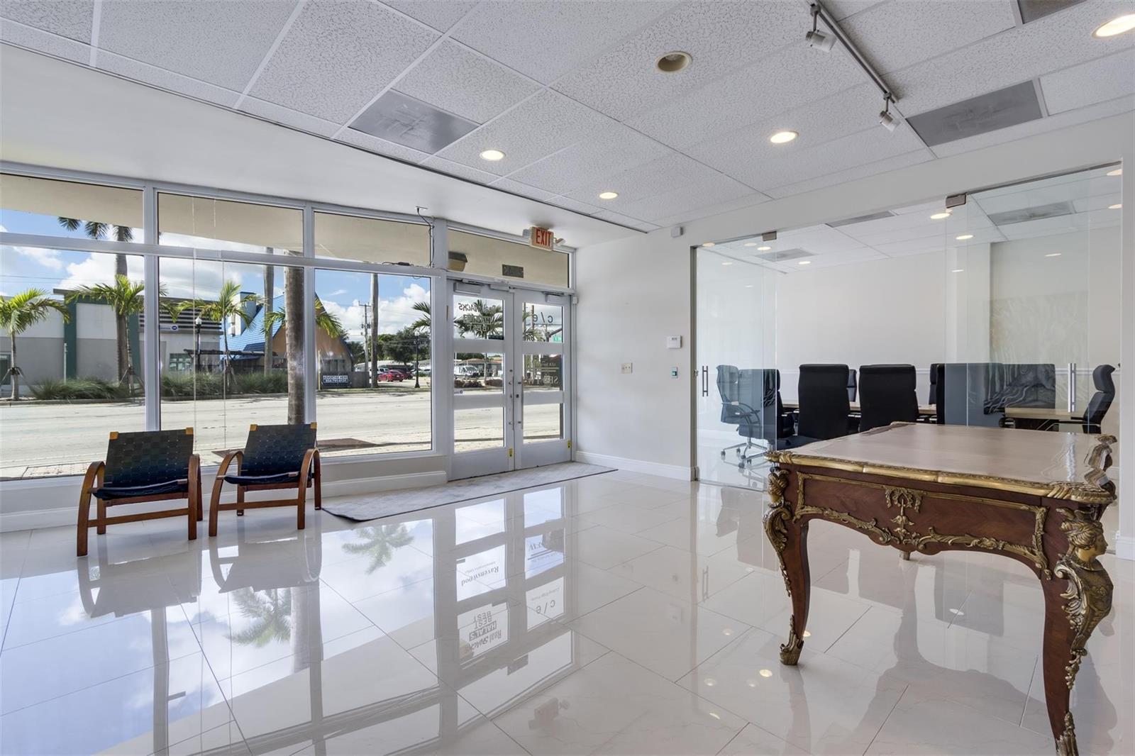 A bright office lobby features white tile floors, a glass-walled conference room, and street views — 2743 Hollywood Boulevard, Hollywood FL 33020, HOLLYWOOD, FL