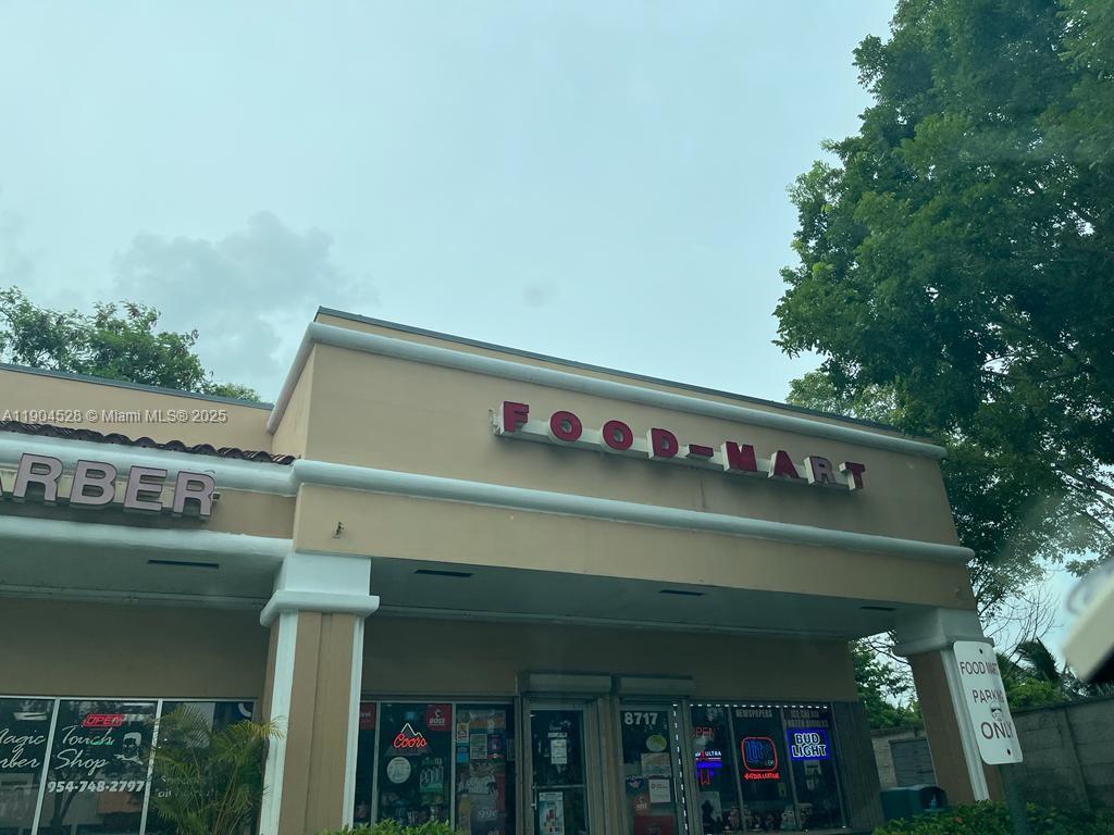 The exterior of a commercial building features a Food-Mart sign and an adjacent barber shop — 8717-8723 NW 50, Lauderhill FL 33351, LAUDERHILL, FL