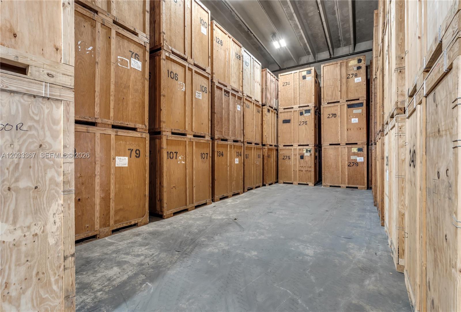 A warehouse interior features rows of stacked wooden storage crates on a concrete floor — 150 SW 14th Ave, Homestead FL 33030, HOMESTEAD, FL