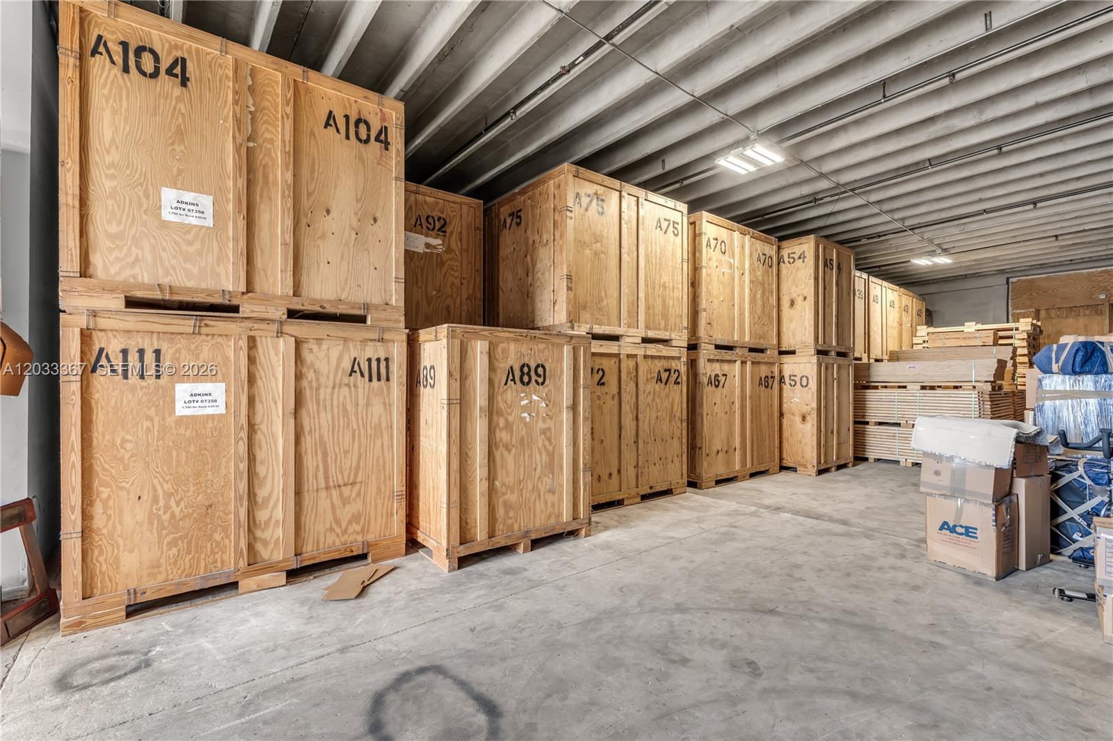 A warehouse interior features rows of stacked wooden storage crates on a concrete floor — 150 SW 14th Ave, Homestead FL 33030, HOMESTEAD, FL