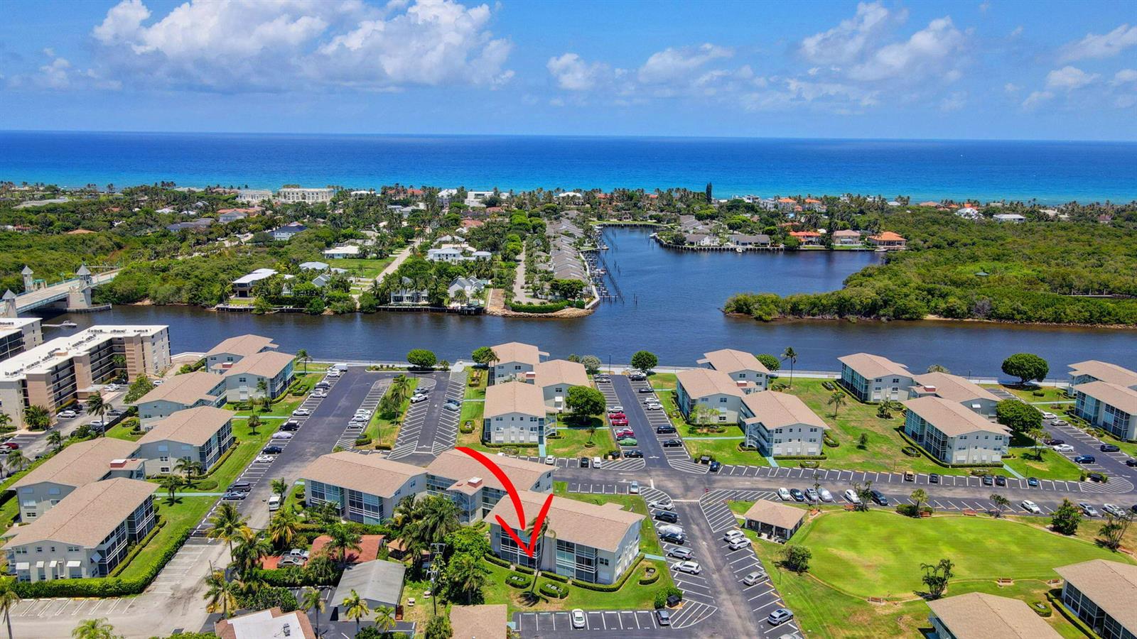 An aerial view shows a multi-story apartment complex with a red arrow pointing to a unit — 210 Horizons E # 103, Boynton Beach FL 33435, BOYNTON BEACH, FL