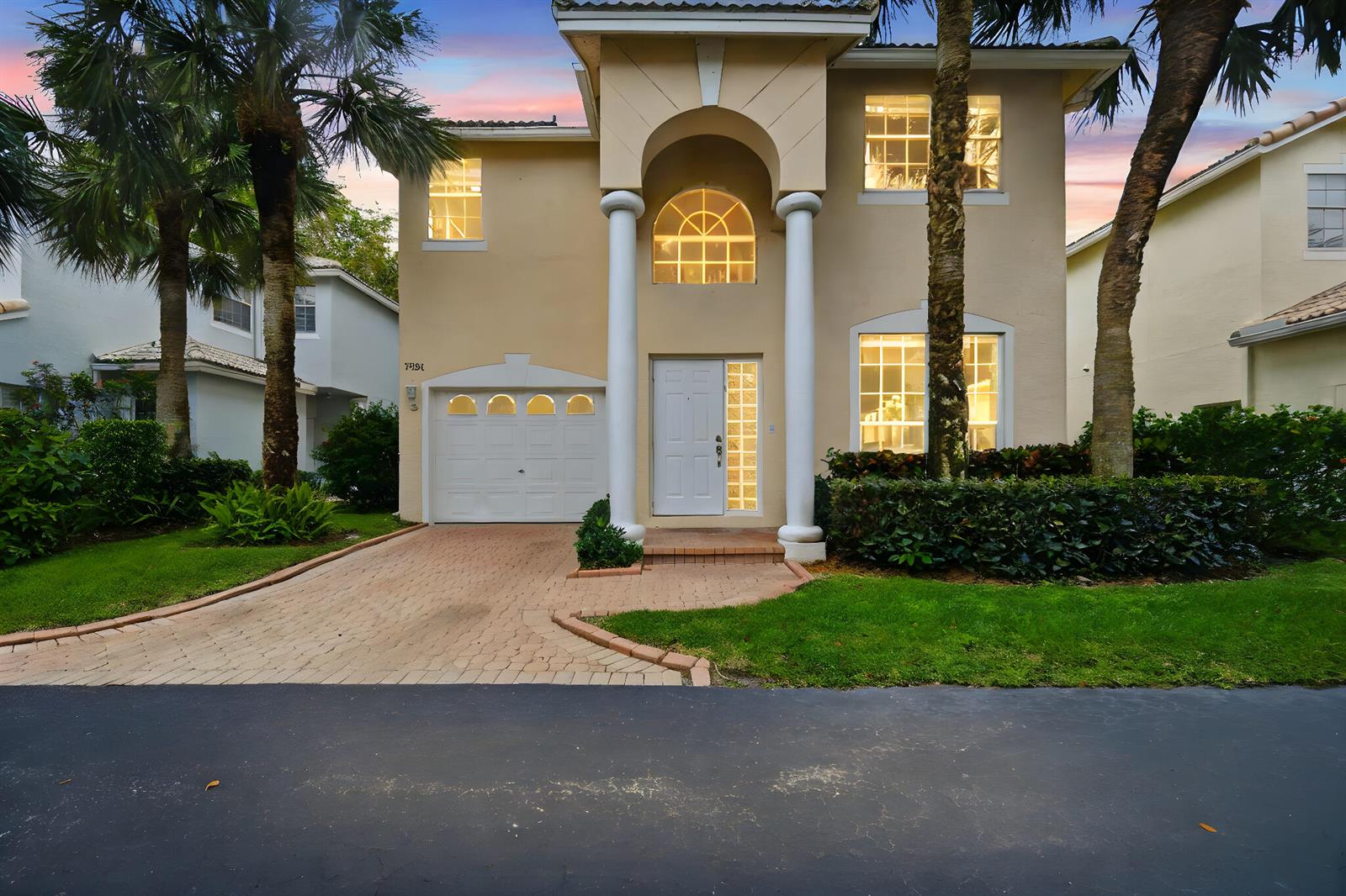 A two-story beige house with a paved driveway, white columns, and a single-car garage — 7331 Panache Way, Boca Raton FL 33433, BOCA RATON, FL