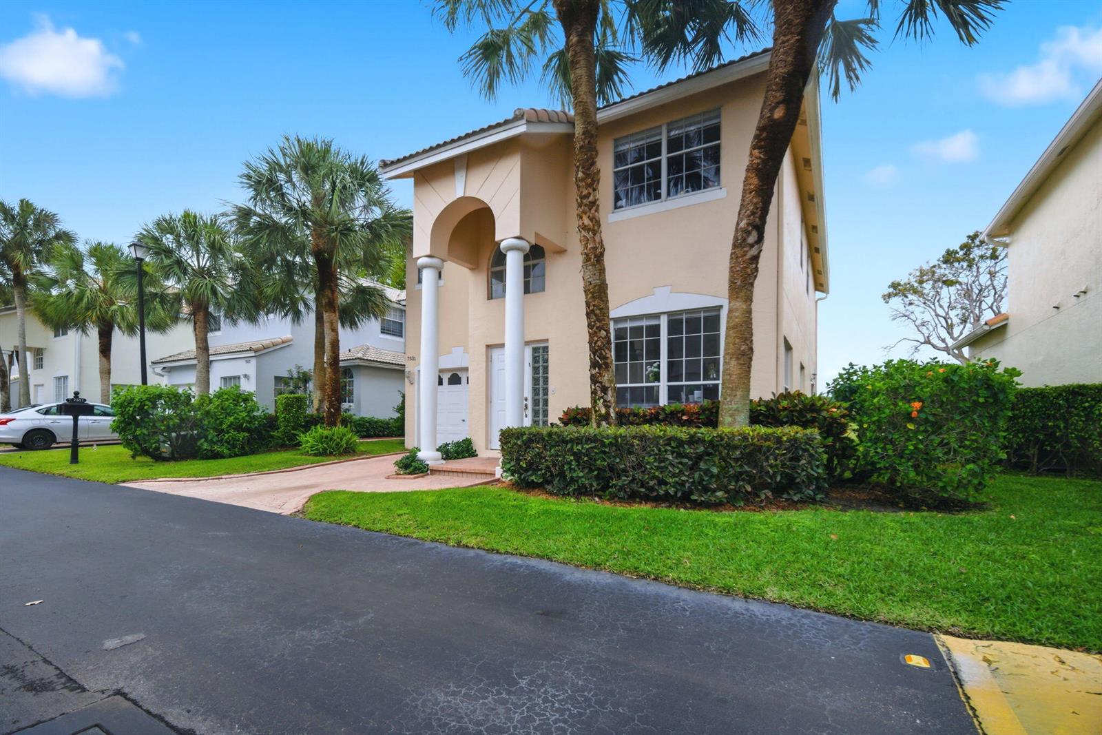 A two-story house with a columned entryway, palm trees, and a paved driveway — 7331 Panache Way, Boca Raton FL 33433, BOCA RATON, FL
