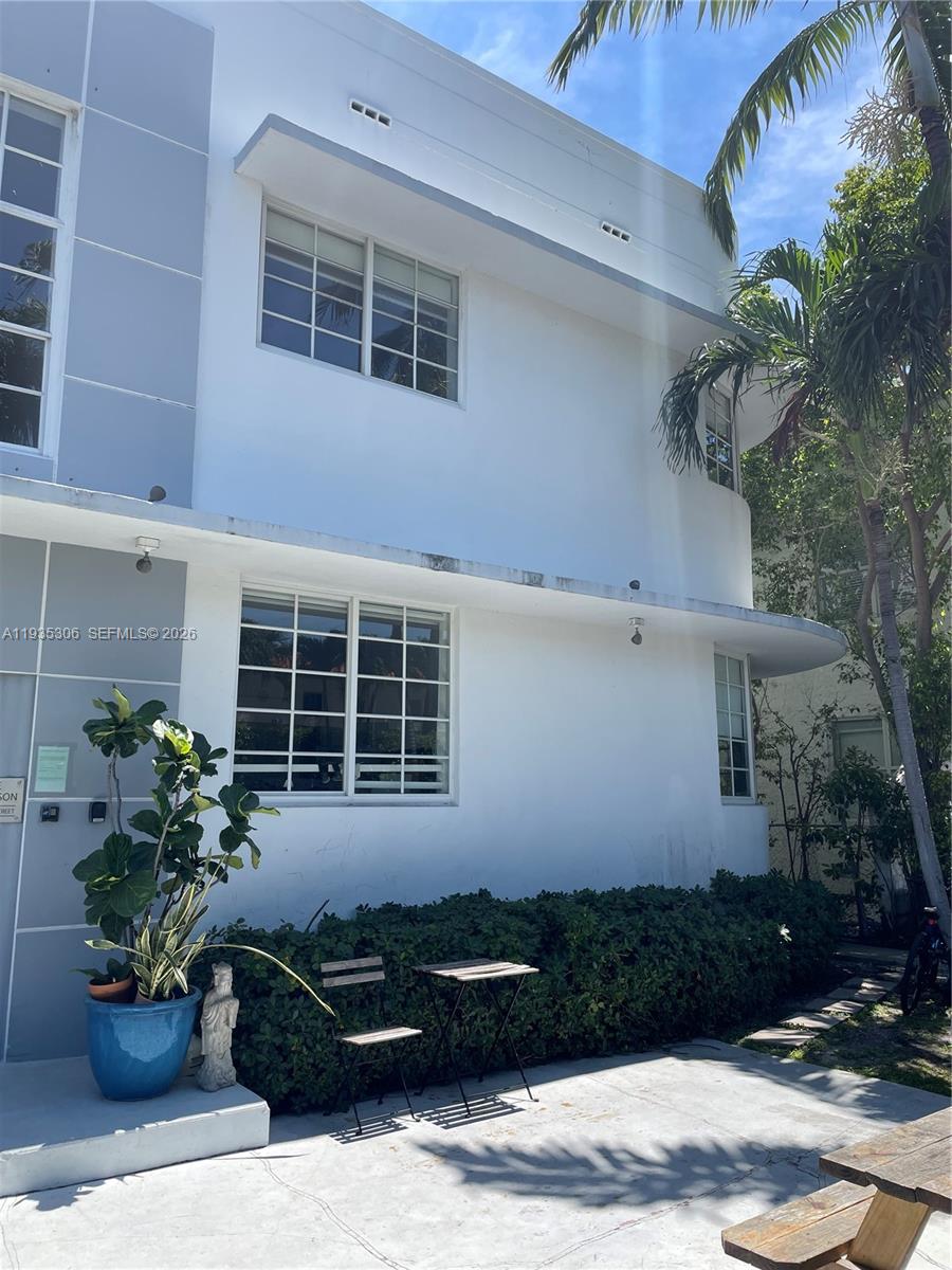 A two-story white building features grid-patterned windows, a flat roofline, and a small patio area — 600 15th St # 10, Miami Beach FL 33139, MIAMI BEACH, FL