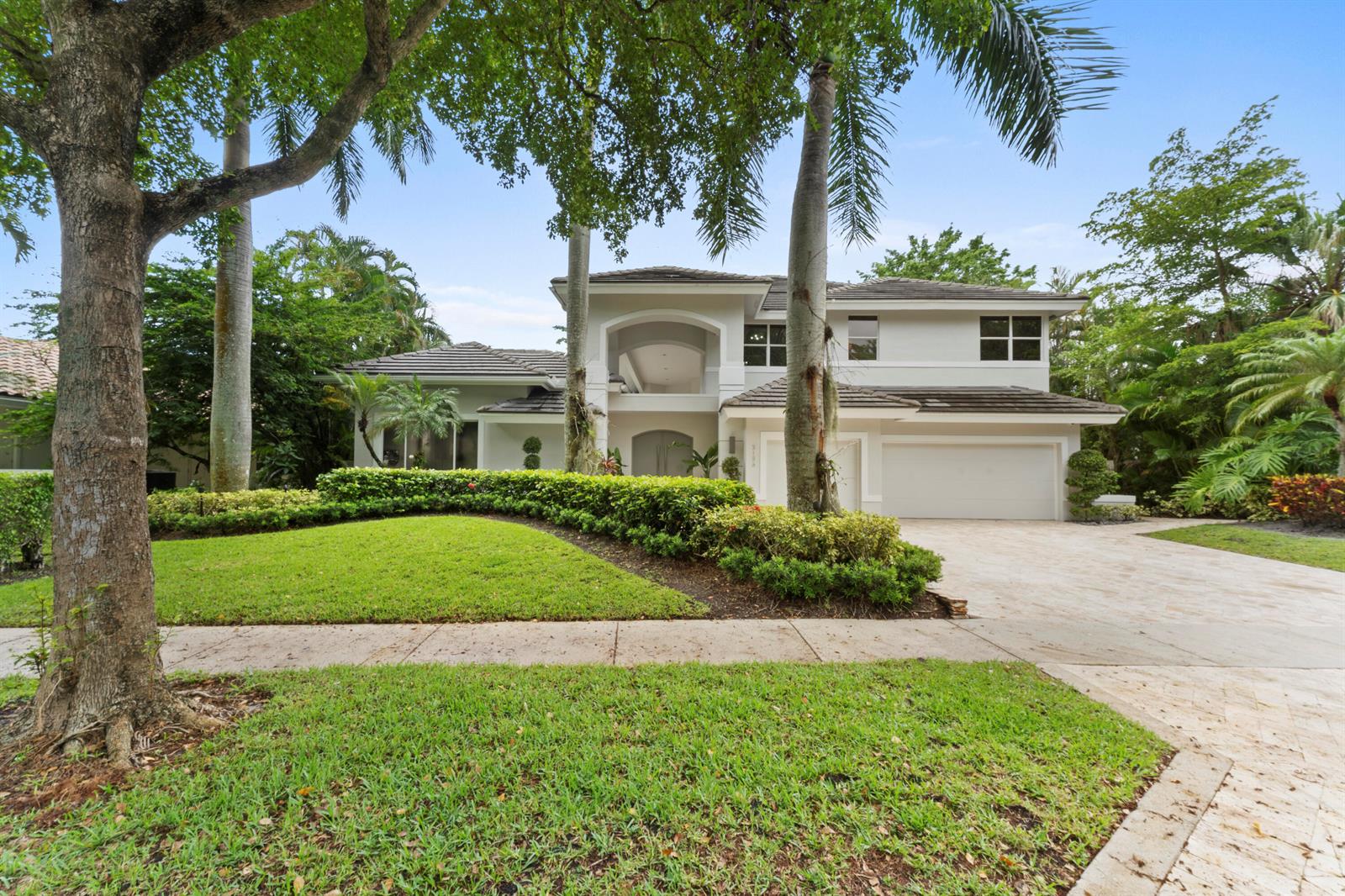 A two-story house with a beige exterior, a tiled roof, and a paved driveway — 3156 NW 61st Street, Boca Raton FL 33496, BOCA RATON, FL