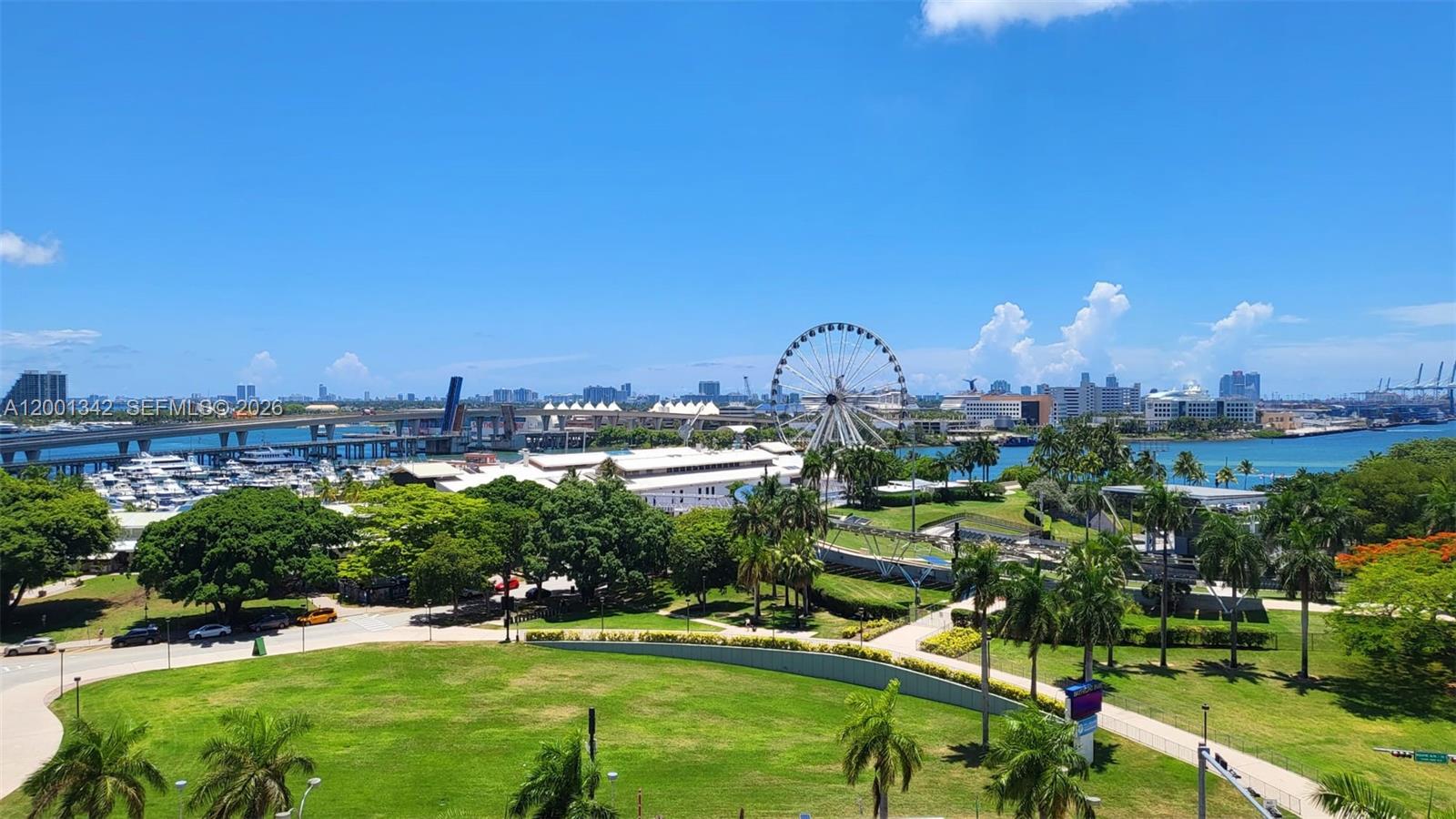 An elevated outdoor view of a park, a large Ferris wheel, and a bridge — 253 NE 2nd St # 1004, Miami FL 33132, MIAMI, FL
