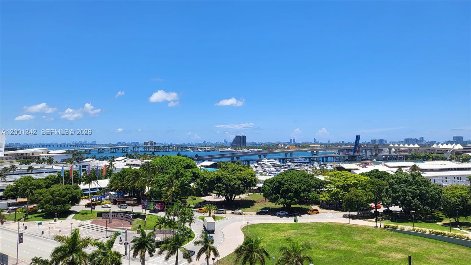 An elevated outdoor view shows a park, a marina, and a bridge under a blue sky — 253 NE 2nd St # 1004, Miami FL 33132, MIAMI, FL