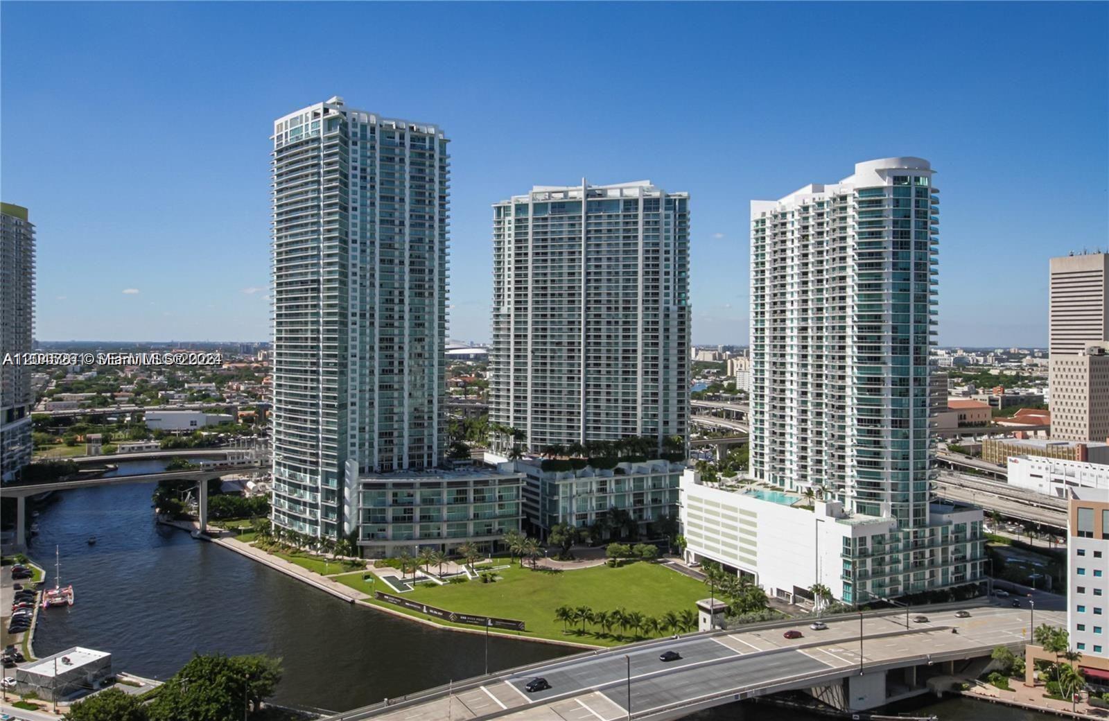 Three tall residential towers stand beside a river with a bridge in the foreground — 92 SW 3rd St # 3608, Miami FL 33130, MIAMI, FL