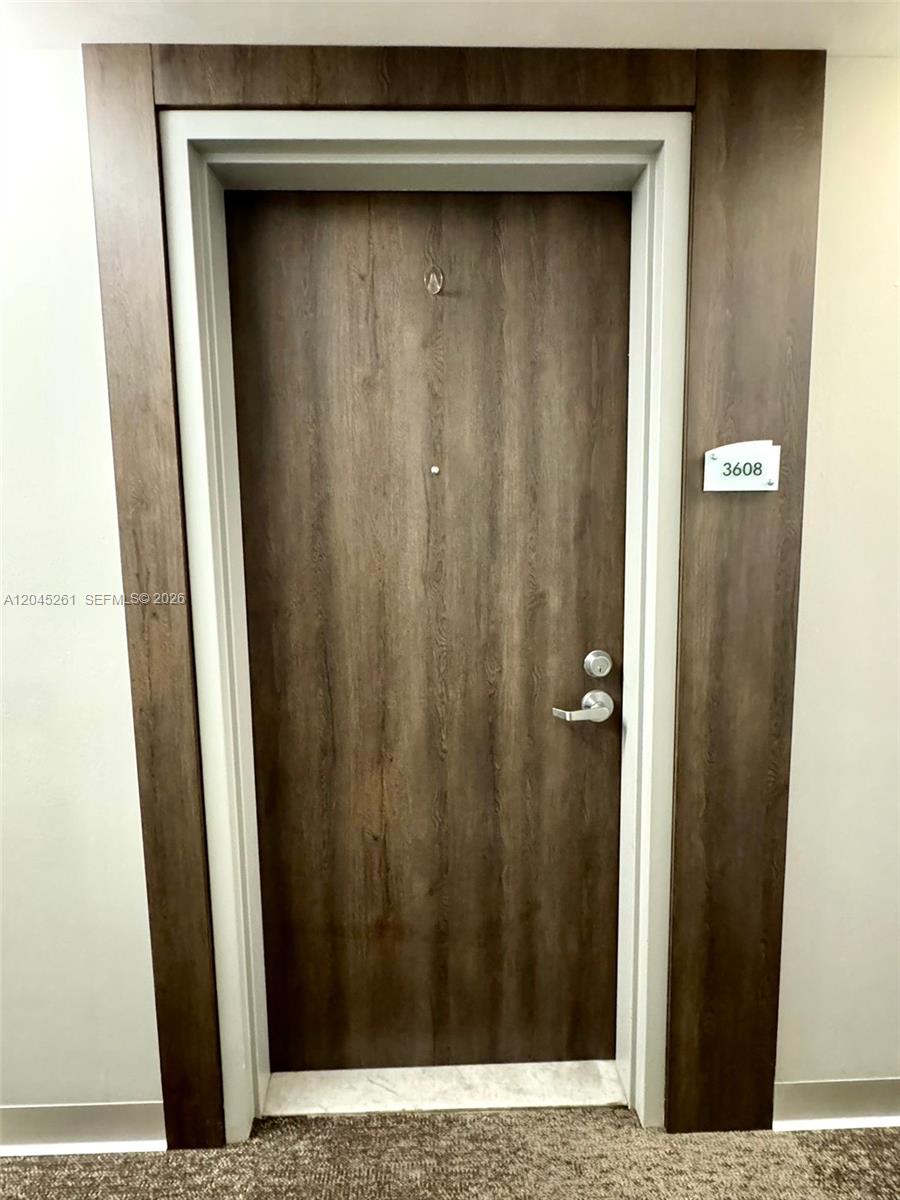 A dark wood-grain door with a silver handle and a unit number sign — 92 SW 3rd St # 3608, Miami FL 33130, MIAMI, FL