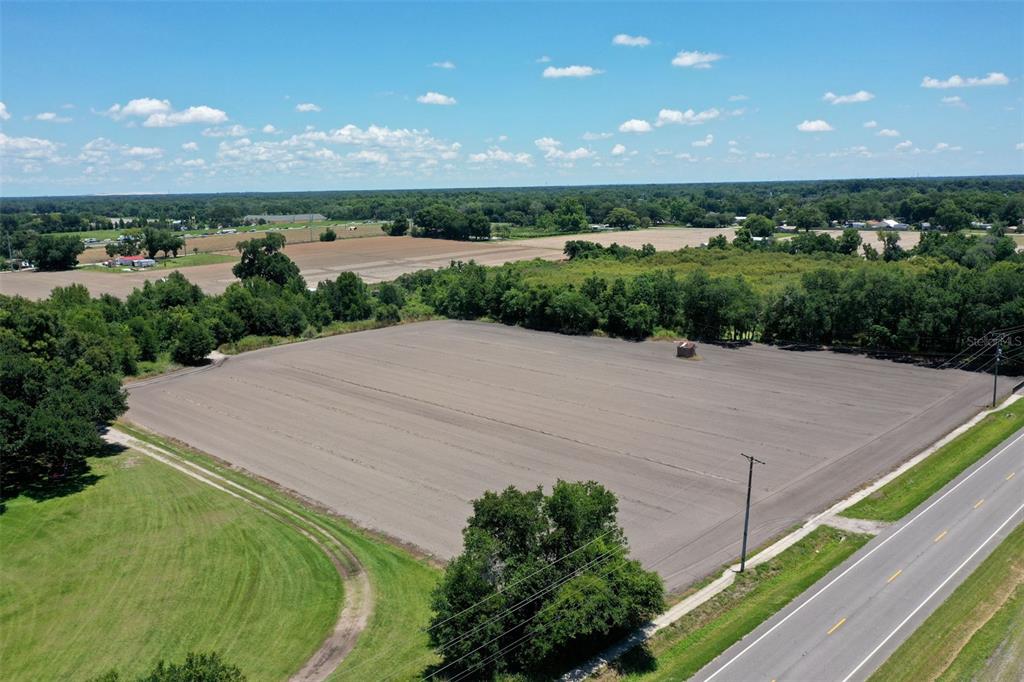 An aerial view shows a large, cleared rectangular plot of land bordering a paved road — 5617 GLEN HARWELL ROAD, PLANT CITY, FL