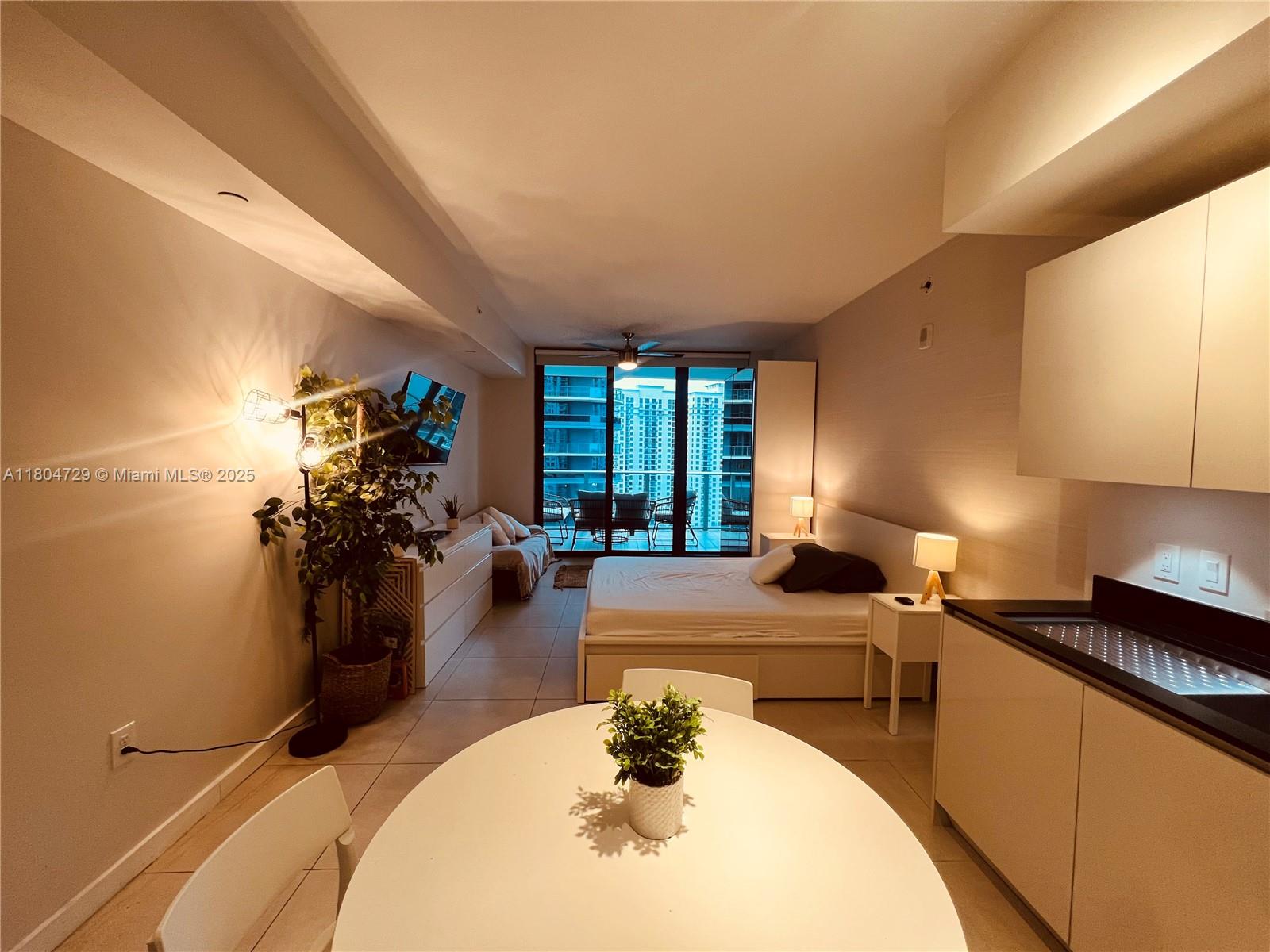 A studio apartment features a kitchen, dining area, bed, and a balcony with city views — 1010 Brickell Ave # 2710, Miami FL 33131, MIAMI, FL